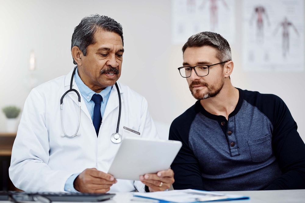 A doctor going over information with a patient