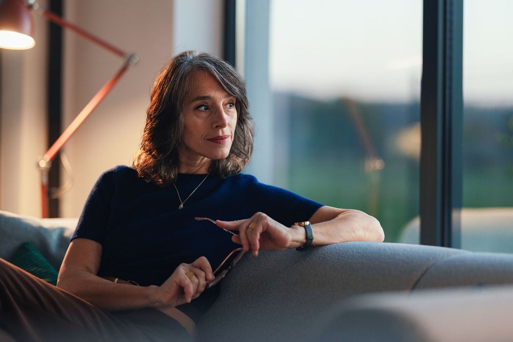 A woman at home, thinking a decision over